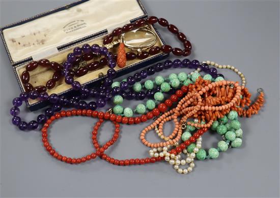 Assorted necklaces including coral and amethyst, a carved coral pendant and a pair of folding lorgnettes.